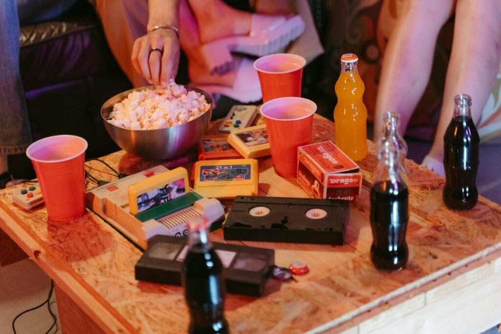 VHS tapes, solo cups and video games sit atop a plywood table