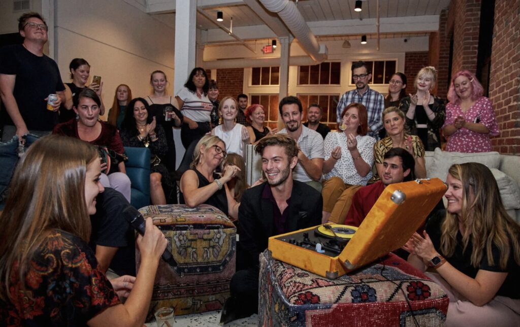 Friends sitting in a living room playing games at a PowerPoint party