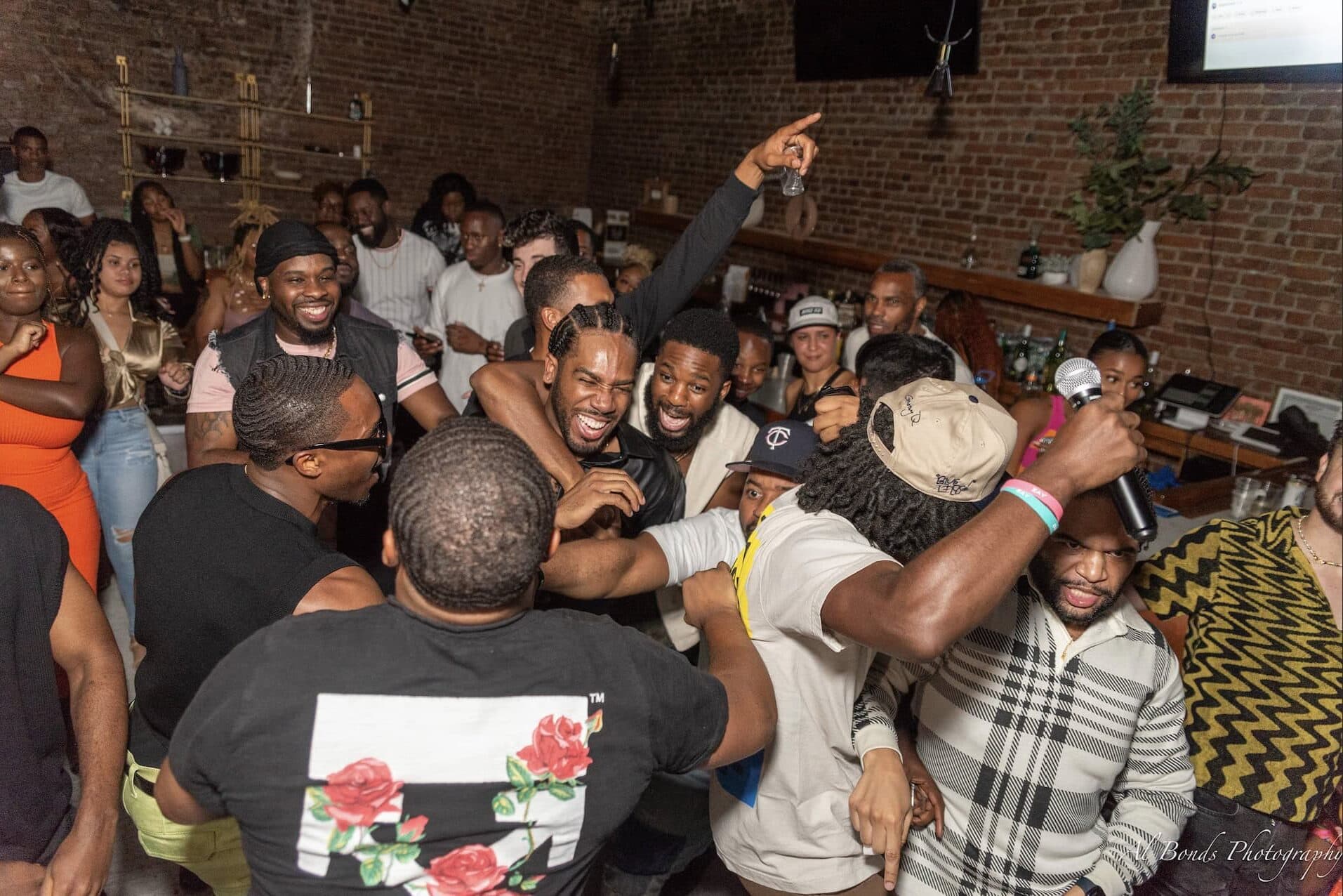 Large group of people celebrating and hugging at brother's birthday party