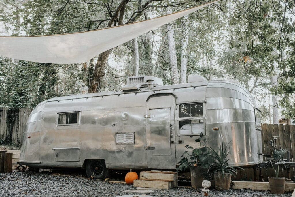 Airstream trailer with sailcloth covering and pumpkins in front