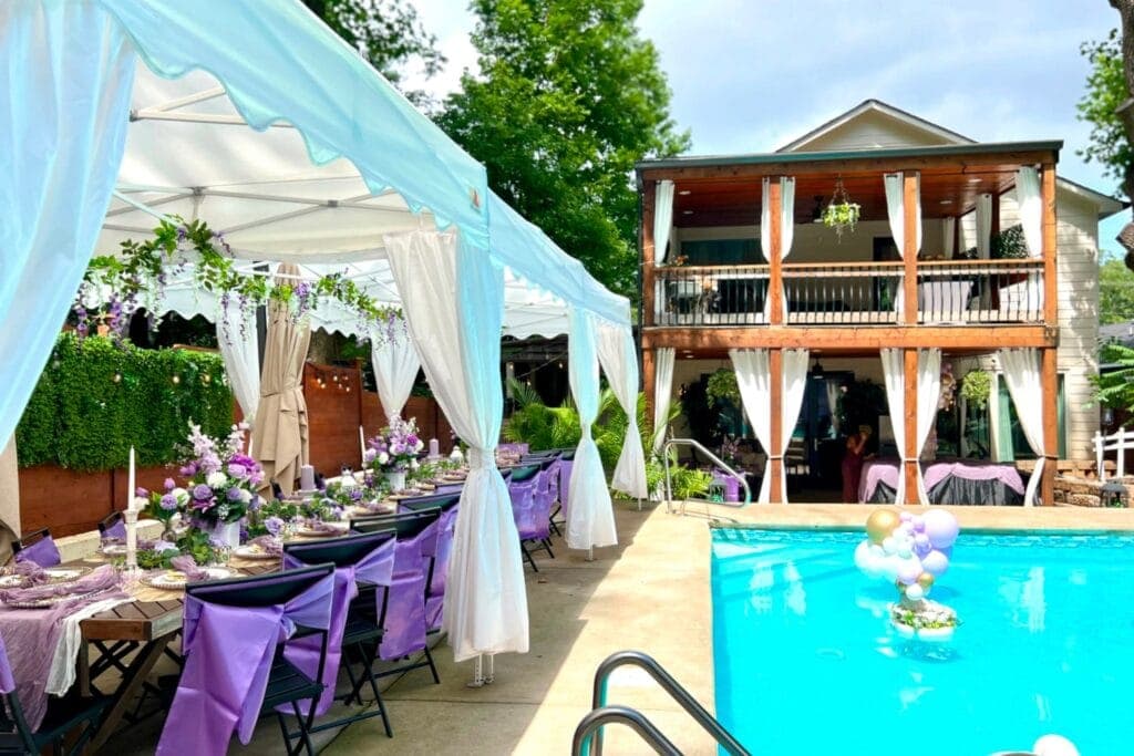 Outdoor venue with pool and veranda set up for party