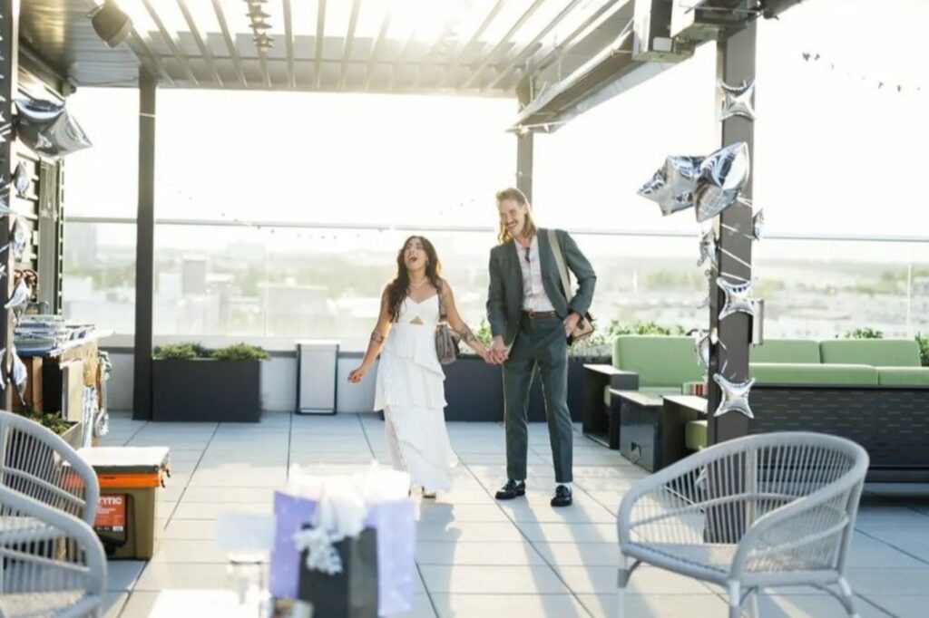 couple celebrating engagement at a rooftop peerspace