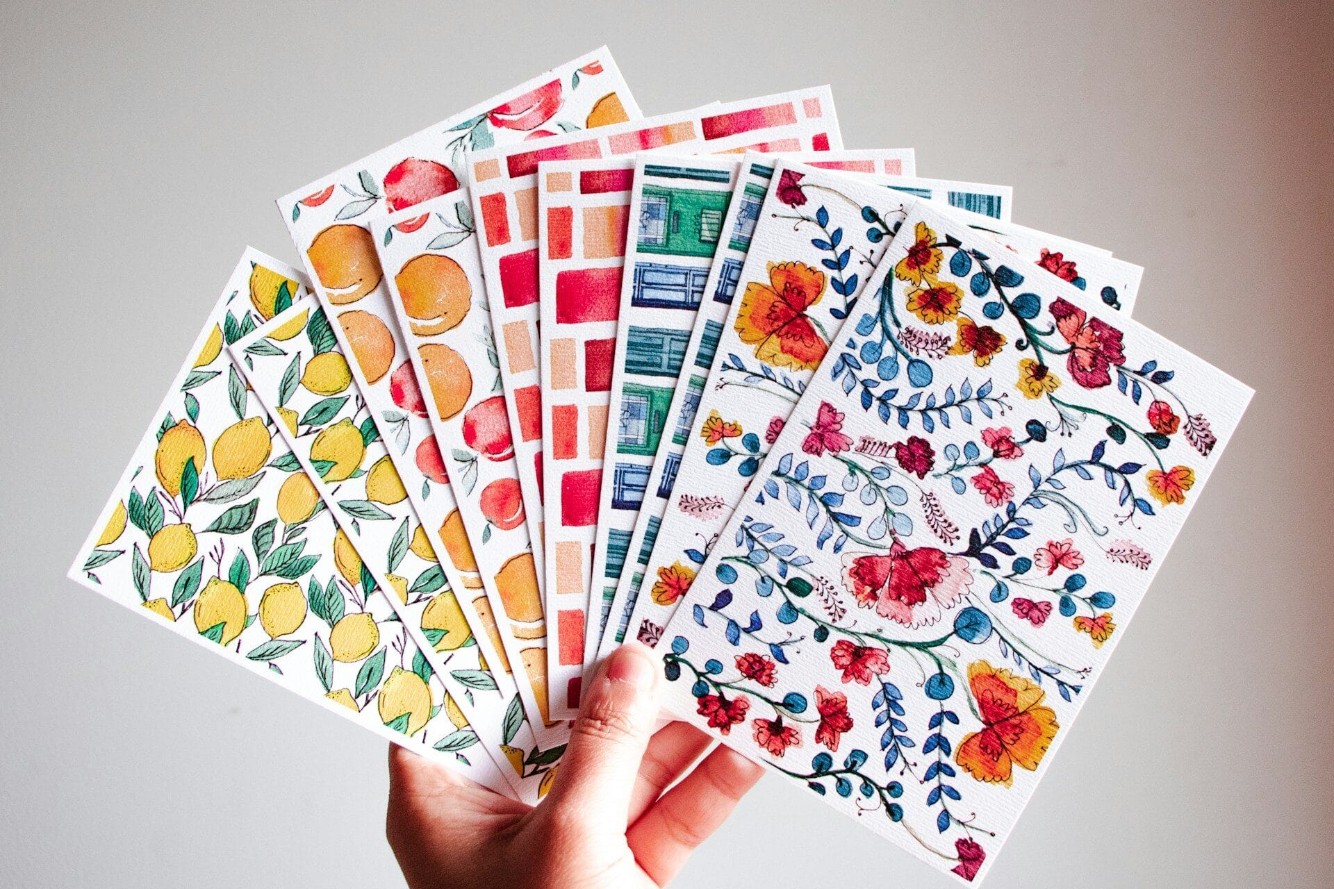 Set of a dozen colorful postcards being held for a Galentine's invite idea