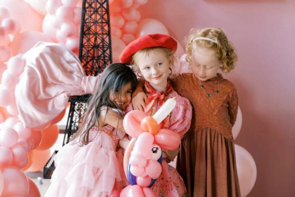 three kids hugging at party