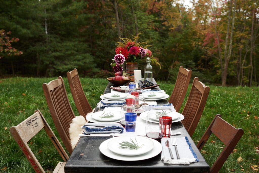 A festive fall table is set up outdoors