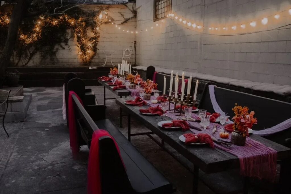 Outdoor Peerspace friendsgiving venue with long table, decor, and string lights in NYC
