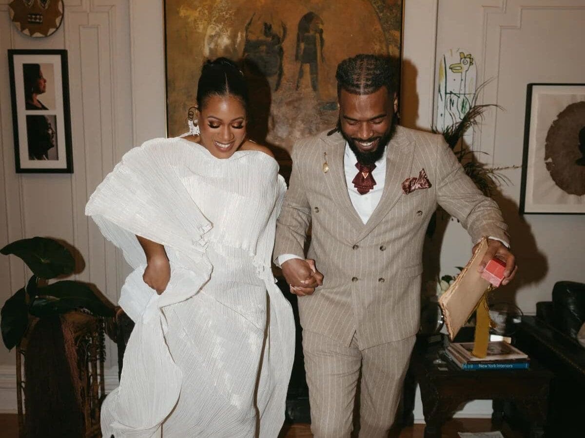 Couple stomping on broom in small wedding at home