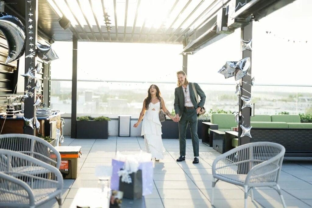Couple entering small wedding reception venue on rooftop