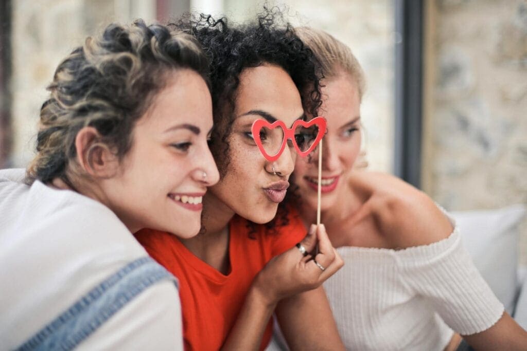 Three women taking photo for Galentine's day decor idea
