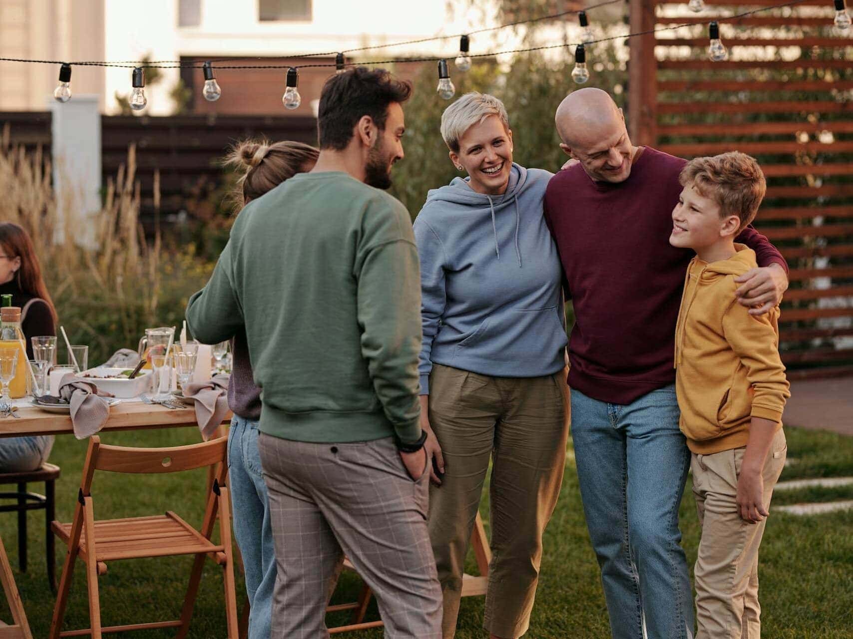 Family standing around dad at outdoor dad birthday party