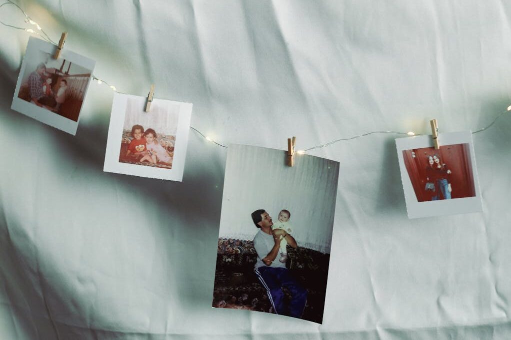 Family photos hung on wire with clothespins for small wedding at home ideas
