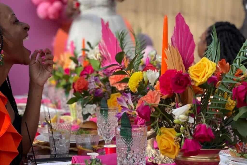 woman laughing at a dinner party